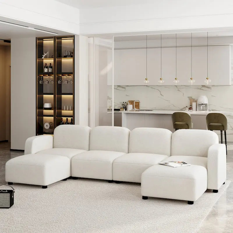 Canapé d'angle modulable en velours en forme de U, 6 places, avec deux poufs, design réversible pour un espace de vie personnalisable.