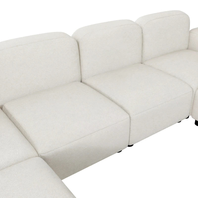Canapé d'angle modulable en velours en forme de U, 6 places, avec deux poufs, design réversible pour un espace de vie personnalisable.