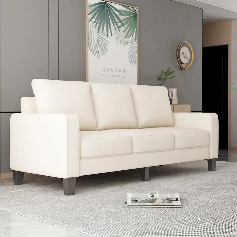 Canapé en tissu beige avec accoudoirs carrés et dossier capitonné